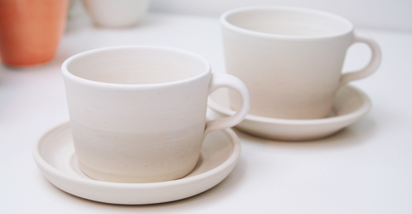 Custom cups and saucers by Ingrid Tufts